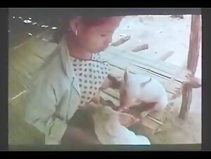 Sex scene with animals: a woman breastfeeds a dog