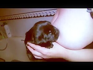 Sex scene with animals: a woman breastfeeds a dog
